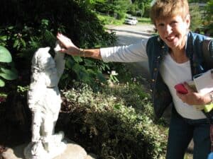 Lily Dale, NY (H) Adele Bowen high-fives a gnome in Lily Dale. Could gnomes actually be real?