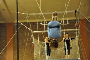 Joan_Chicago_Trapeze_School(13) Joan Anudnsen with legs hooked over the trapeze