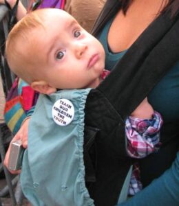 A baby wears a protest button at Occupy Wall Street.
