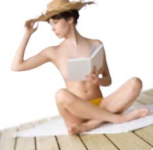 A nude woman reading a book