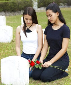 Two girls mourning the victim of a mass shooting in Colorado