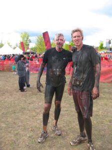 Malcolm Logan and Curt Logan covered with mud at the Warrior Dash