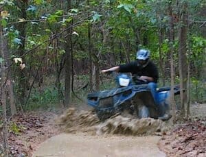 I drove the ATV through the mud, twisting the throttle for all I was worth.