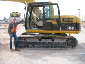 Malcolm Logan with excavator at Dig This Heavy Equipment Playground